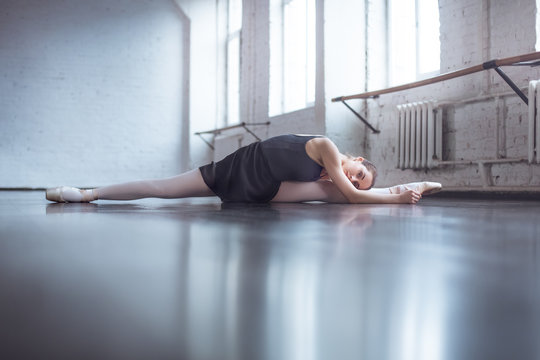 Young ballet dancer practice twine stretching in studio active lifestyle