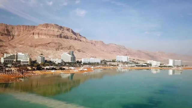 Aerial footage of the Dead Sea hotels and beaches area, flying above the salty water