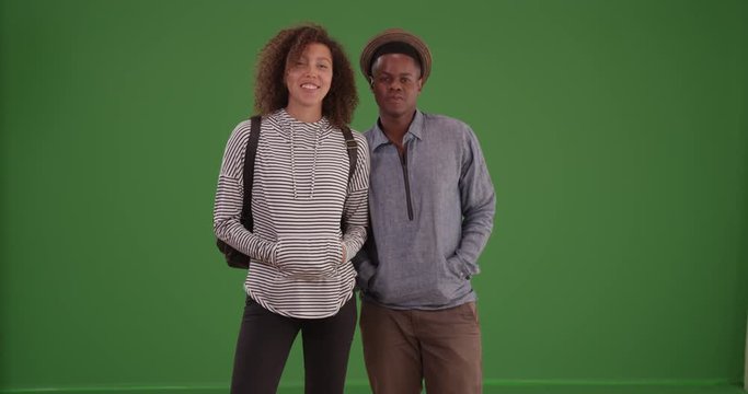 Black woman stares off on green screen. On green screen to be keyed or composited. 