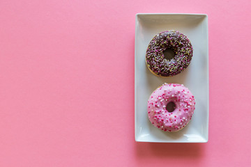 Donuts on pink background with space for copy