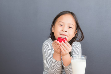 Cute little girl eating sweet macarons