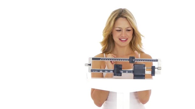 Young woman on scale happy about her weight