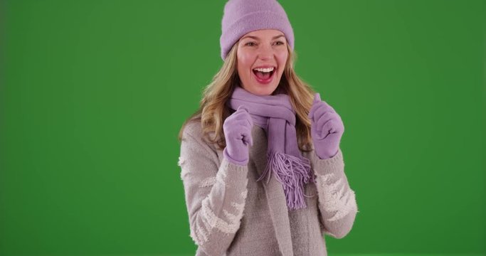 Middle aged Caucasian woman enjoying the snow outside on green screen. On green screen to be keyed or composited.