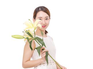Beautiful and smiling young woman holding a yellow lily
