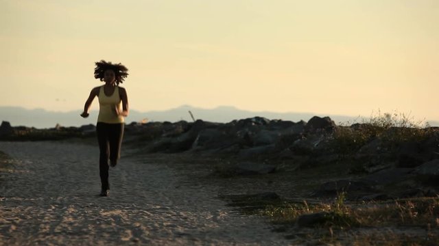 Young woman running on the beach