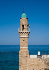 Old mosque's minaret over Mediterranean sea in old  Jaffa,  Israel.