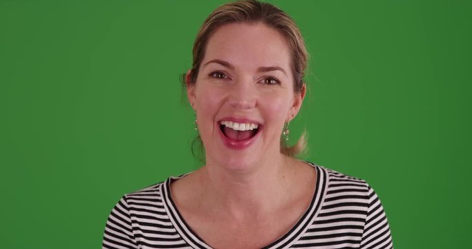 Caucasian woman having video chat from the pov of the computer on green screen. On green screen to be keyed or composited.