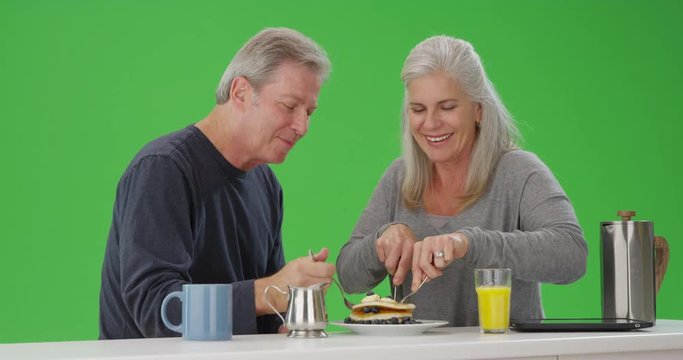Portrait of elderly couple having breakfast together