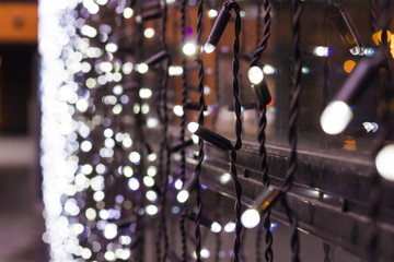 Naklejka na ściany i meble Christmas lights with bokeh. Garlands on New Year window