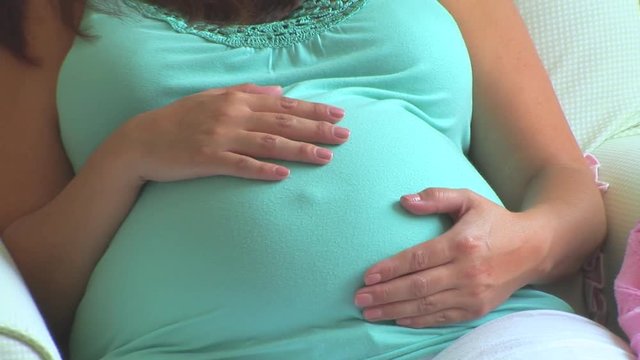 Pregnant woman caressing belly