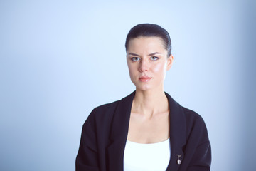 Fototapeta premium Young woman standing, isolated on gray background