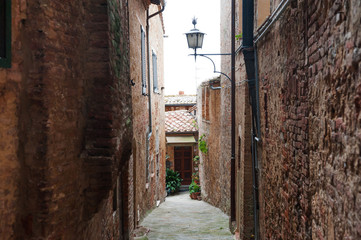 Medieval characteristic narrow street in the historical center of Montepuliciano city near Siena, Tuscany, Italy
