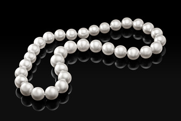 Luxury white pearl necklace on a black background with glossy reflection