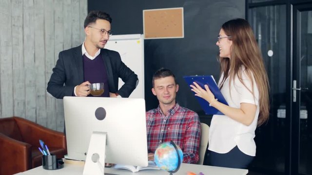 Coworkers in a modern office working on project in company