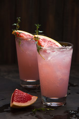 Homemade grapefruit lemonade with ice in glass