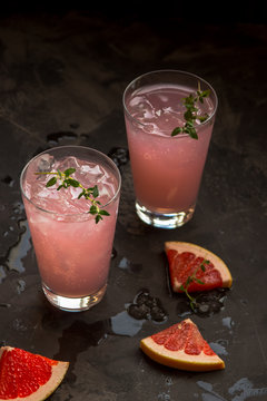 Homemade grapefruit lemonade with ice in glass