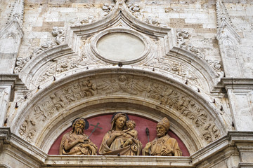 Montepulciano, province of Siena, Tuscany, Italy - detail of the facade of a church with marble sculpture in the city center