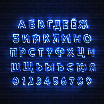 Russian neon font. Glowing alphabet, electric stand, against a brick wall background, Electric Abc..