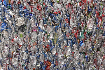 Crushed, smashed and compressed aluminum beverage cans, scrap metal recycling.