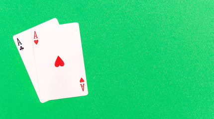 Two aces on a green background. Copy space. Top view.