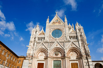 Fototapeta na wymiar Scenic view of the facade of gothic renaissance church Santa Maria Assunta, cathedral of Siena, Tuscany, Italy