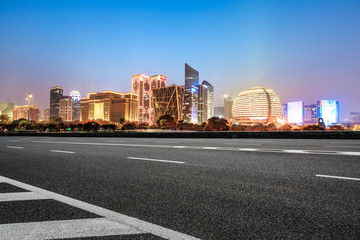 Asphalt highway and modern city buildings in hangzhou qianjiang new city at night