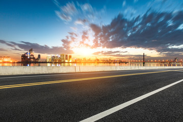 Asphalt highway and modern city buildings in hangzhou qianjiang new city at sunset