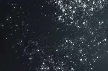 Kitchen background. Flour on a dark wooden background. Top view. / Christmas night. Snow on a dark...