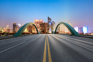 Asphalt highway and modern city buildings in hangzhou qianjiang new city at night