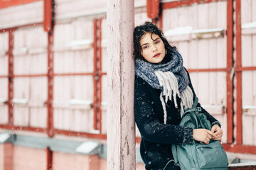 Winter portrait of a pretty girl dressed in warm clothes