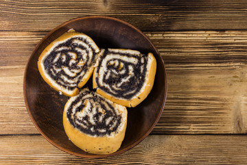 Poppy seed rolls on wooden table