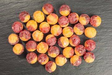 orange sea buckthorn and cherry flavored candy on slate plate