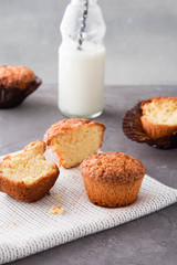 Homemade vanilla muffins with a bottle of milk.
