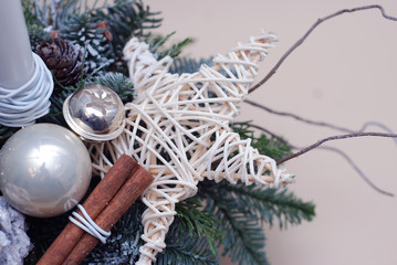 Close up a Star Decorated Christmas tree Fir Branch Arrangement or Copmosition with Cinnamon Sticks and Silver Baubble, or Globes.