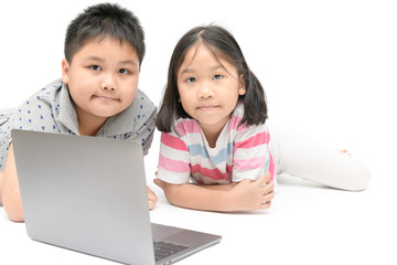 cute sister and young brother play laptop isolated