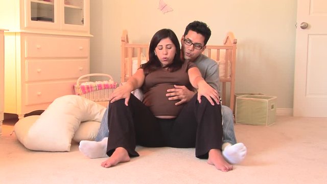 Pregnant couple practicing breathing exercises