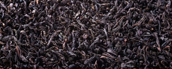 Background with black tea with copy space. Selective focus. Banner.