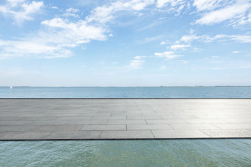 Fototapeta na wymiar Outdoor viewing platform and lake landscape under the blue sky