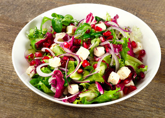 Healthy salad with feta cheese and pomegranate.