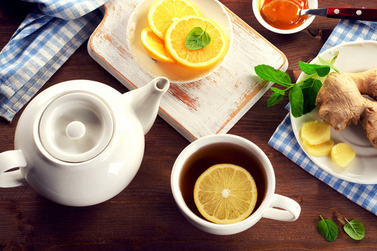 Tea with lemon, ginger, honey  and mint on a wooden background. View from above