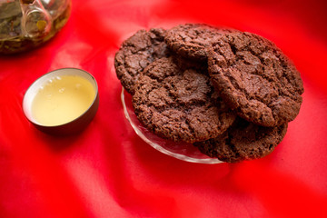 still life, a cup of tea and biscuits, on a red beautiful background with a divorce