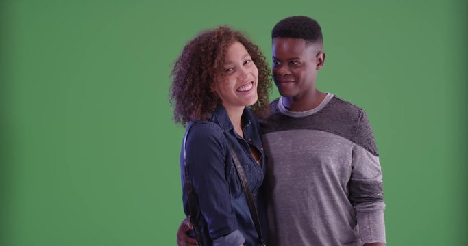 Millennial African American couple pose for a portrait on green screen. On green screen to be keyed or composited. 