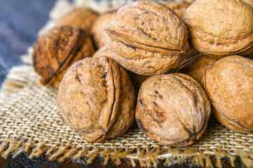 Shell and walnut bones on a brown wooden table.