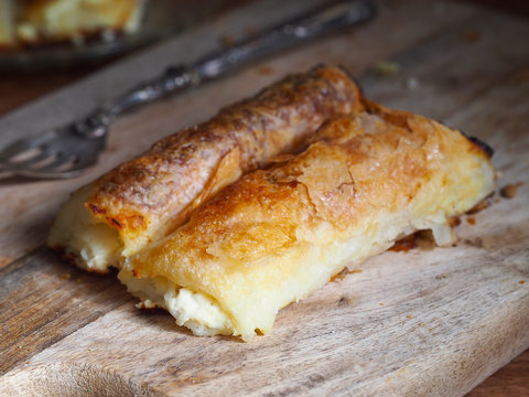 Strukli, traditional Croatian cheese snack on wooden background. Sweet or salty.