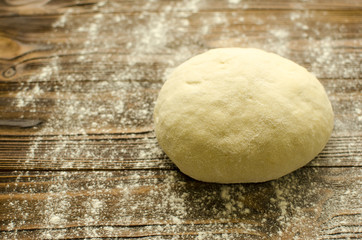 Dough on wooden background