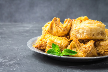 baklava turkish traditional delight on a dark wood background. toning.
