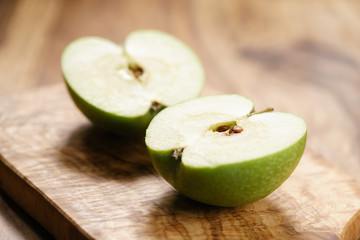 green apple on wood board closeup