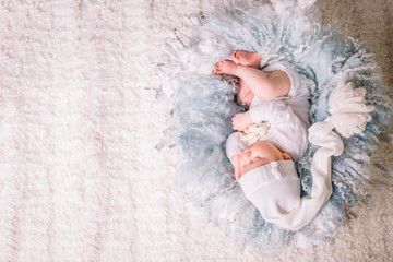 sweet baby in sweet dream. newborn two weeks in white clothes sleeping in light blue. the concept of childhood © alfa27