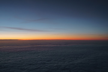 clouds in early morning during flight on a plane
