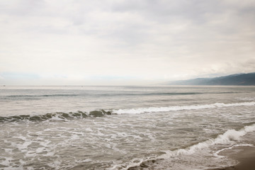 ocean waves on Santa Monica beach in cloudy november day